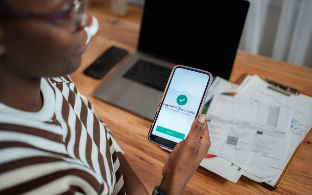 Empreendedora conferindo pagamento como parte da rotina financeira